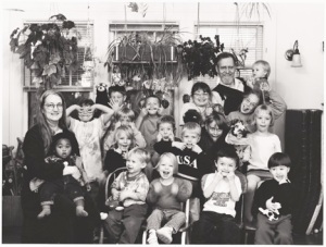 Group photo of kids and adults, black and white.