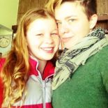 Angela wearing green sweater with a younger person wearing a red jacket